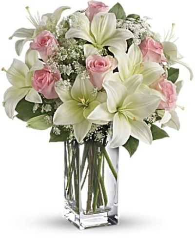 <div id="mark-3" class="m-pdp-tabs-marketing-description">Stunning in its simplicity, this innocent harmony of light pink roses and snow white lilies are a heartfelt way to send your very best. The classic, clear rectangular glass vase keeps the focus on the heavenly beauty of the blooms.</div>
<p> </p>
<div id="desc-3">
<ul>
<li>Light pink roses and white asiatic lilies form a fragrant bouquet with delicate touches of Queen Anne's lace and rich green salal.</li>
</ul>
</div>