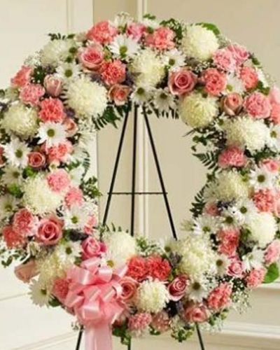 <p>Finding the perfect expression of your care and concern during difficult times requires thoughtful consideration. This standing wreath - crafted from exquisite pink and white flowers such as roses, alstroemeria, and carnations accented by baby's breath, salal, heather and more - beautifully reflects the love and sympathy that is in your heart. Appropriate for family, friends and business associates to send directly to the funeral home.</p>