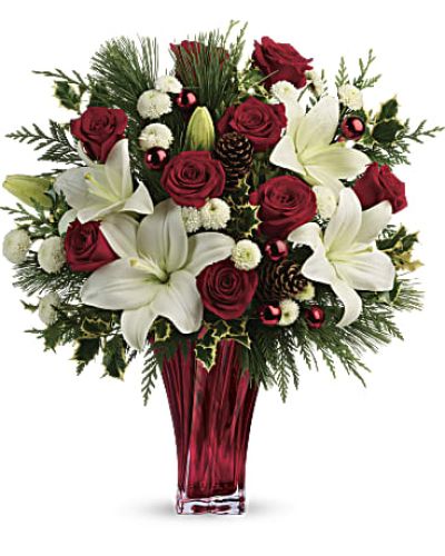 Send them the wonders of winter with beautiful red roses, snow white lilies and fresh winter greens arranged in an elegant glass vase.

Red roses, white asiatic lilies and white button chrysanthemums are accented with fresh flat cedar, variegated holly, white pine, pinecones and red ornament balls.