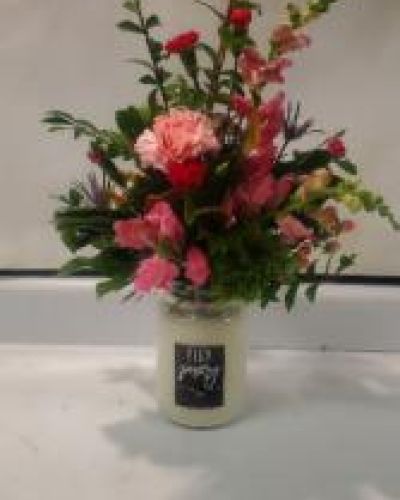 <p>A beautiful assorted flower arrangement made with a scented candle. Get for all occastions.</p>