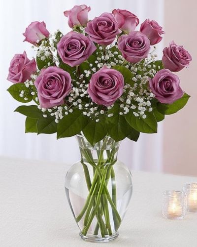 <p>Lavender roses are artfully arranged in a classic glass urn vase. Choose from one dozen,  18 roses or two dozen roses.<del></del></p>
<hr />
<p>&nbsp;</p>